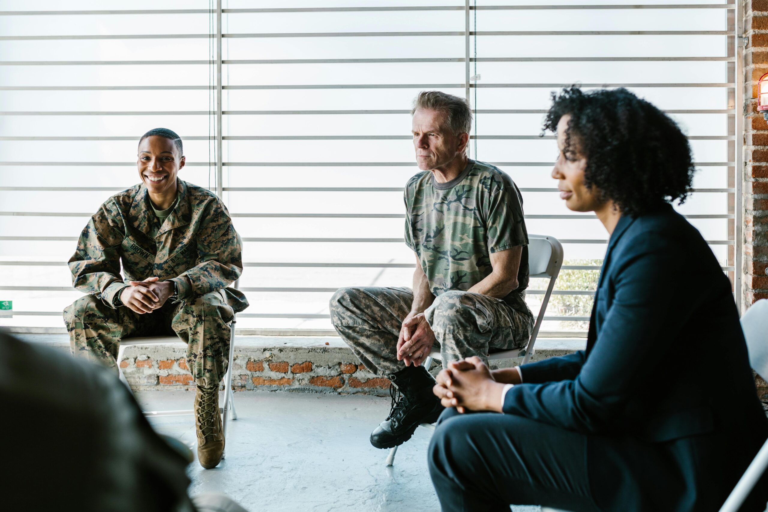 Group of military folks sitting in a circle for counseling.